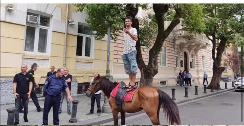 Filming and observing the protest on horseback