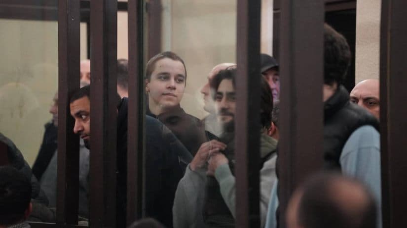 Judge keeps all eight protesters in custody amid courtroom chaos