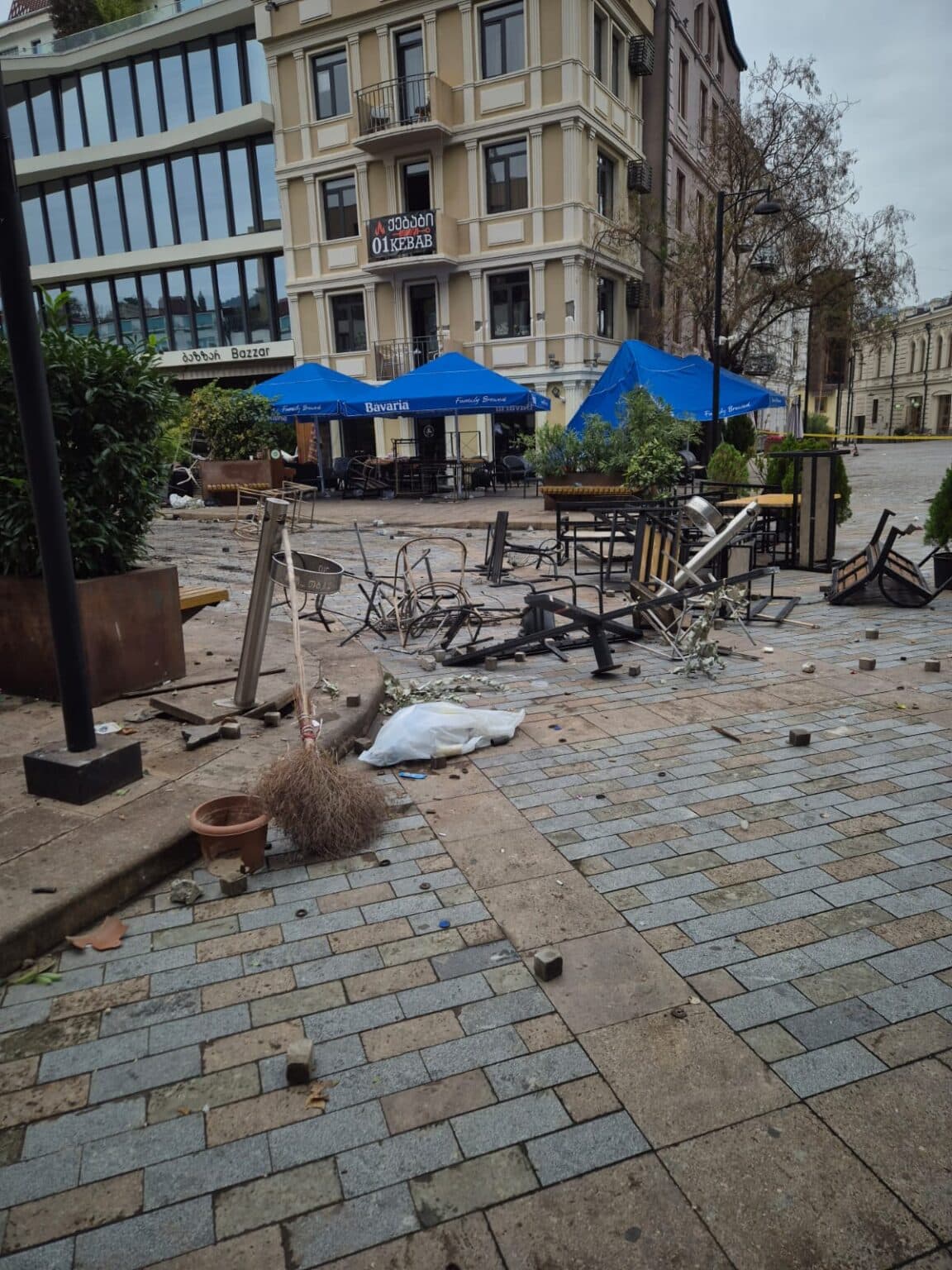 <p style="text-align: justify">The Tbilisi City Hall on Sunday released a statement and photo-video materials detailing damage caused to municipal infrastructure and public property during last night’s protests in the capital.</p><p style="text-align: justify">According to the statement, the protests resulted in harm to several cultural heritage sites and city infrastructure, including facades, decorative lighting, and public amenities in central areas.</p><p style="text-align: justify">“Unfortunately, the protests have caused damage to cultural heritage facades, shutters, and parts of artistic decorative lighting installations. On Orbeliani and Tabukashvili Streets and Rustaveli Avenue, pedestrian pavements, cobblestones, streetlight fixtures, and cables were damaged. Decorative lights on Orbeliani Street were torn down and broken, while waste containers on Tabukashvili Street were burned,” the statement said.</p><p style="text-align: justify">City Hall added that street furniture owned by private companies and café operators was also destroyed. The fence surrounding the Presidential Administration’s courtyard was broken, and nearby bollards separating pedestrian and vehicle zones were bent or damaged.</p><p style="text-align: justify">Various other public elements - including swings, plants, flowerpots, and decorative landscaping - were also heavily damaged, with some completely destroyed. Road signs, a barrier gate near the underground parking area, display boards, and a decorative stage above the parking site were reported broken.</p><p style="text-align: justify">Tbilservice Group, the city’s waste and maintenance service, began clean-up work after gaining access to the area. Burnt and broken materials were removed, and the affected locations were cleaned and organised.</p><p style="text-align: justify">“At this stage, municipal departments are working on-site to restore the damaged infrastructure and return the area to its original condition,” the statement concluded.</p>