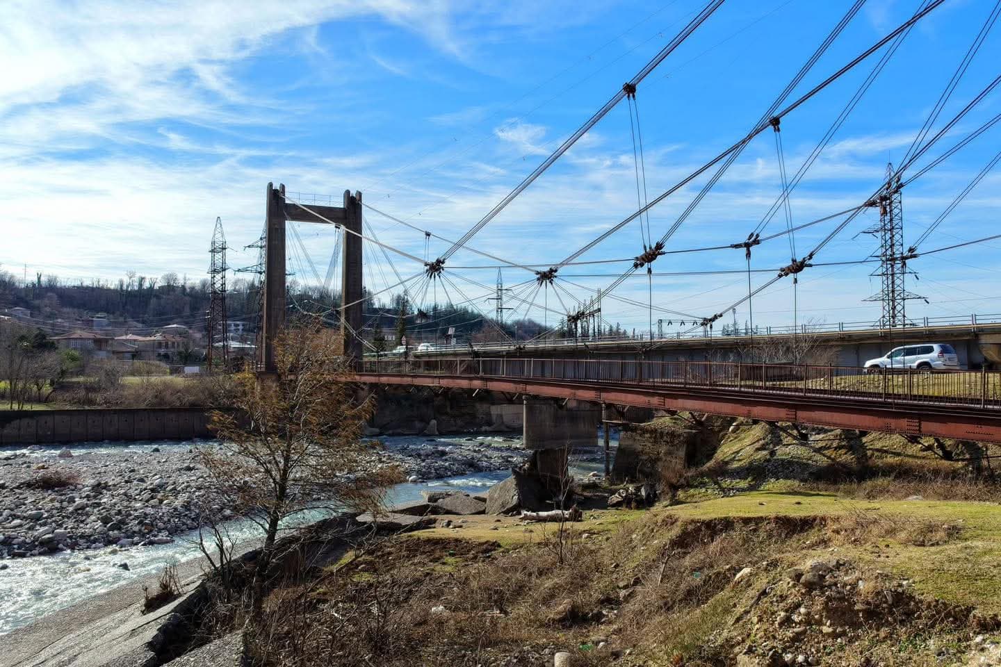 <p style="text-align: justify">Work has begun on a project to rehabilitate the historic suspension bridge over the Magana River in the town of Jvari, in Georgia’s northwestern Tsalenjikha Municipality, and develop it into a tourist attraction.</p><p style="text-align: justify">The initiative is being led by the Ministry of Infrastructure of Georgia, which plans to restore the structure and integrate it into the region’s tourism offering.</p><p style="text-align: justify">The 80-metre pedestrian bridge, built in 1931–1932, is currently damaged. It has been granted the status of a cultural heritage monument.</p><p style="text-align: justify">Infrastructure Minister Revaz Sokhadze inspected the site together with Municipal Development Fund Executive Director Beka Urushadze, Roads Department Chair Levan Darakhvelidze, Member of Parliament Ilia Injia, representatives of the local government, and Enguri Attraction Director Nikoloz Antidze.</p><p style="text-align: justify">Officials reviewed the current condition of the bridge and discussed plans for its rehabilitation and future tourism use.</p>